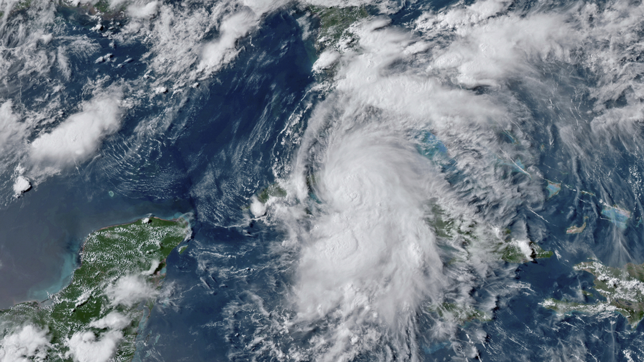 This GOES-16 GeoColor satellite image taken Monday, July 5, 2021, at 4:50 p.m. EDT, and provided by NOAA, shows Tropical Storm Elsa over western Cuba with strong rain and winds. Forecasters say it will move on to the Florida Keys on Tuesday and Florida’s central Gulf coast by Wednesday. The storm is moving over mainly rural areas to the east of Havana on Monday after making landfall near Cienega de Zapata, a natural park with few inhabitants. (NOAA via AP)