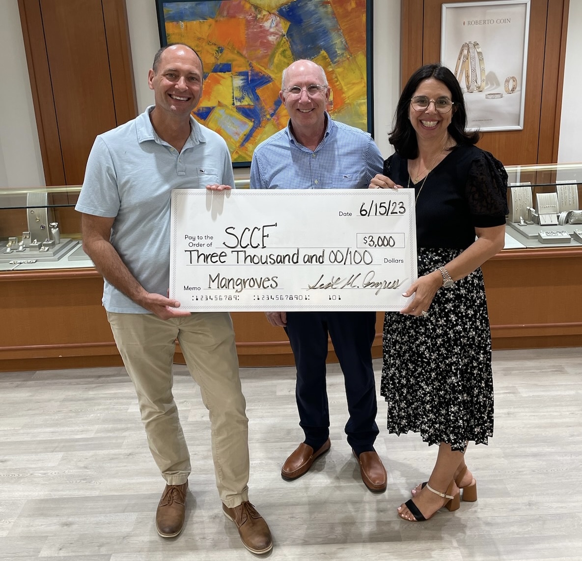 SCCF CEO James Evans receiving donation check from Congress Jewelers