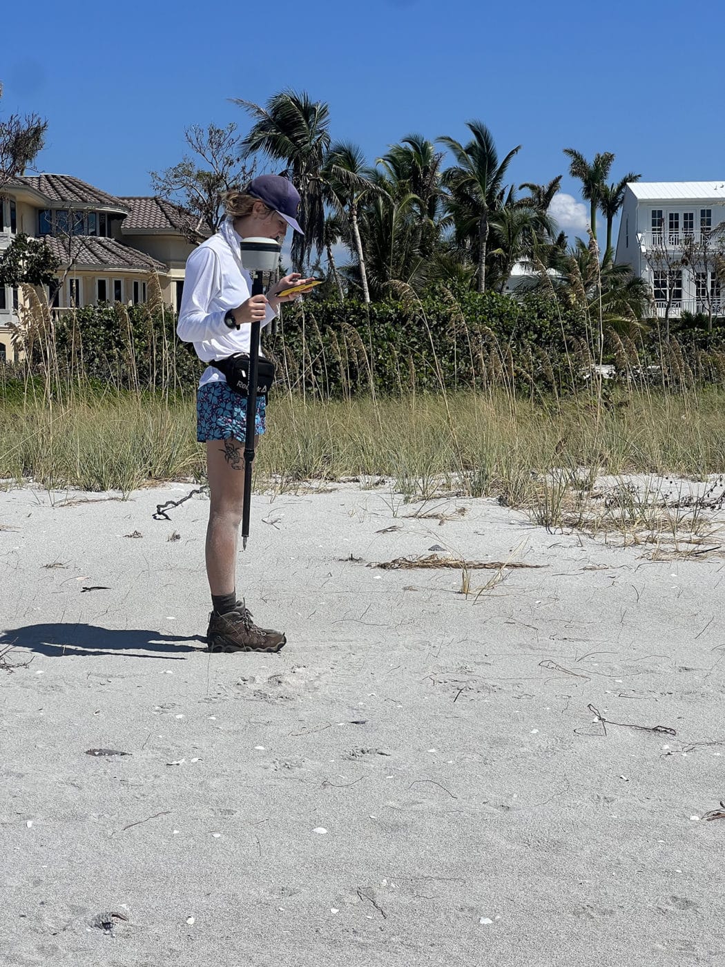 person using GPS on beach post hurricane idalia