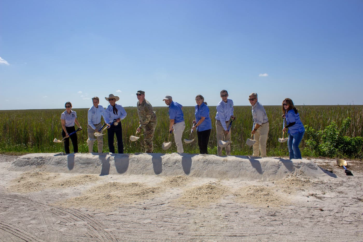 people groundbreaking with shovels