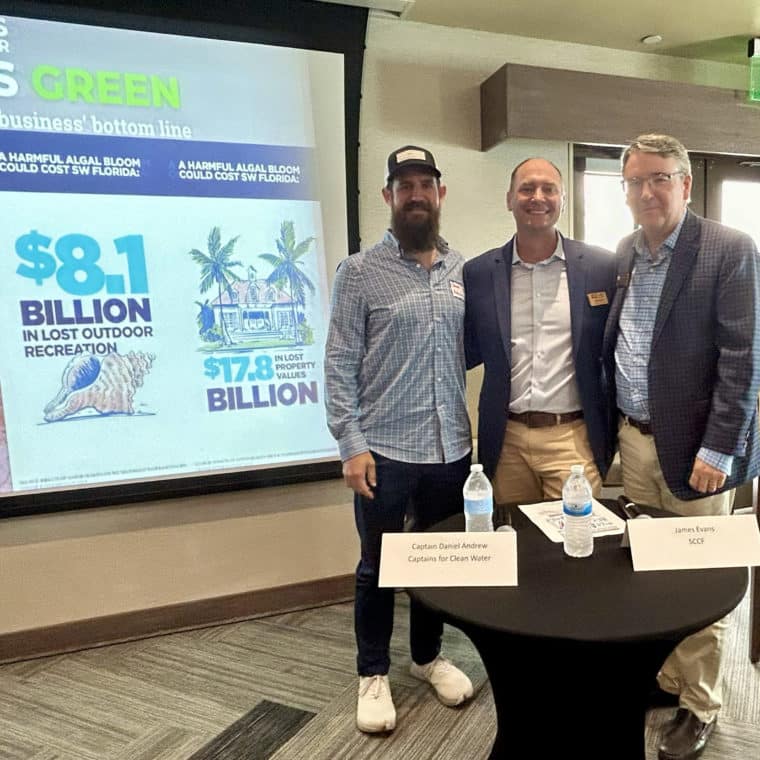 image of three people standing in front of screen