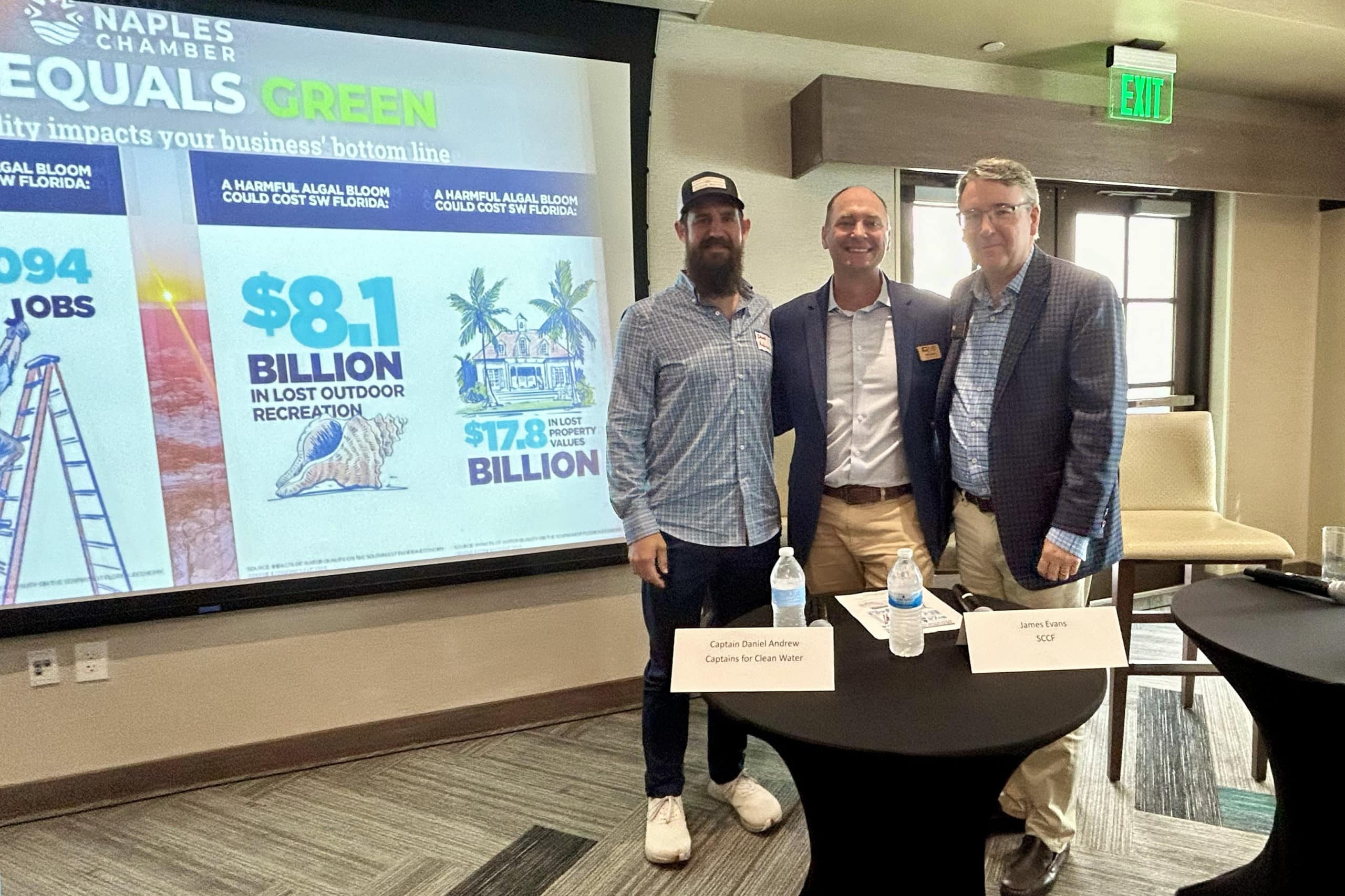 image of three people standing in front of screen