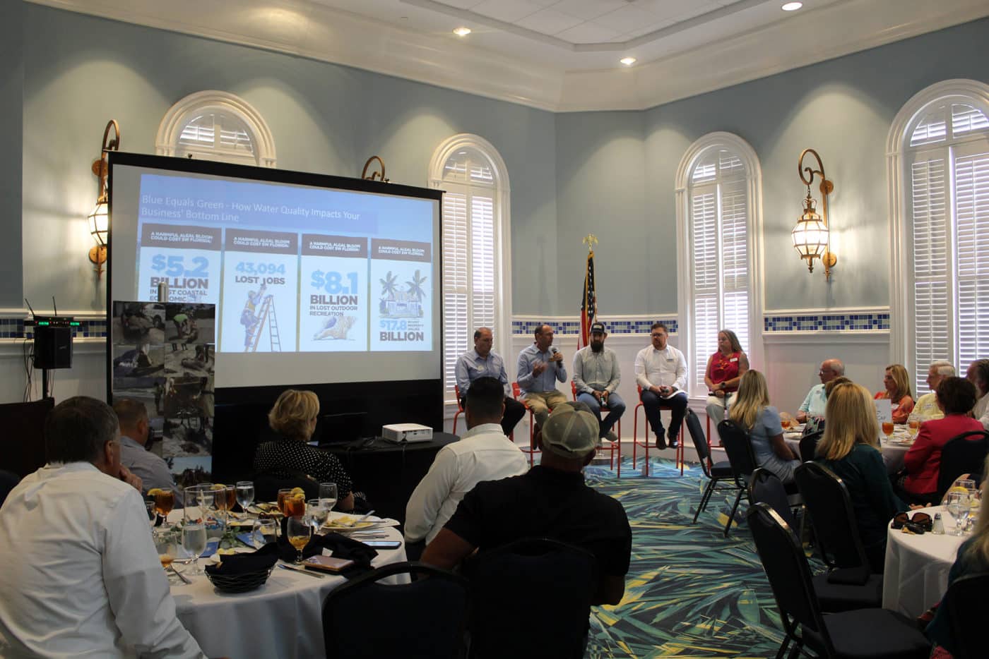 image of panel in front of people indoors