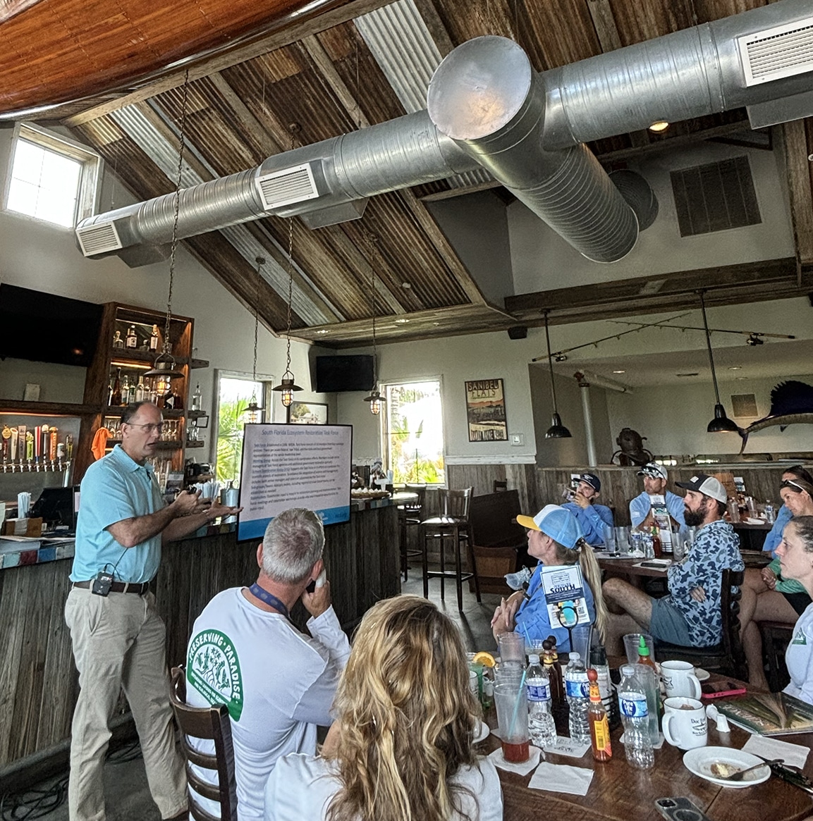 person presenting to a group of people indoors