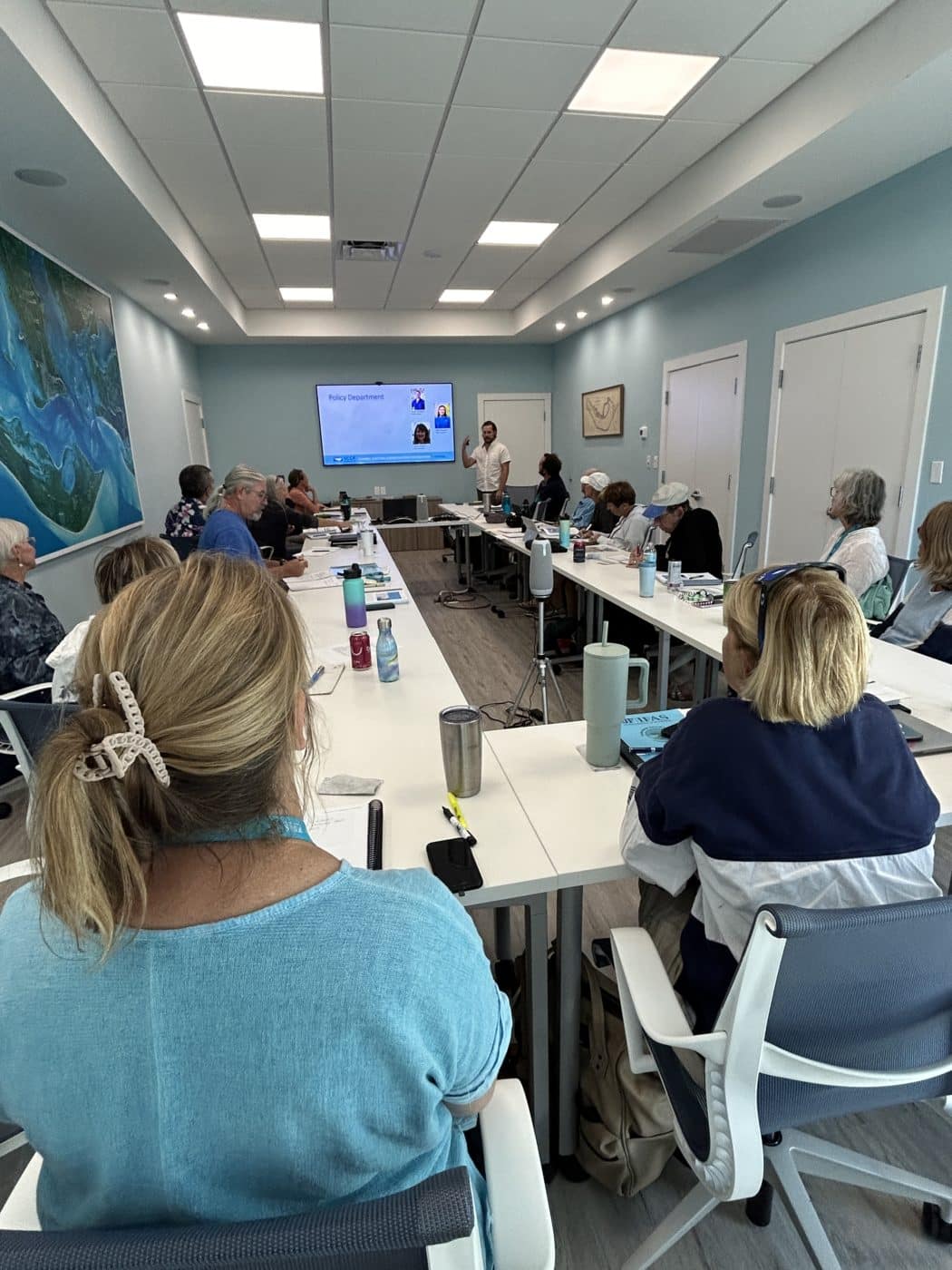 classroom full of people watching a presentation