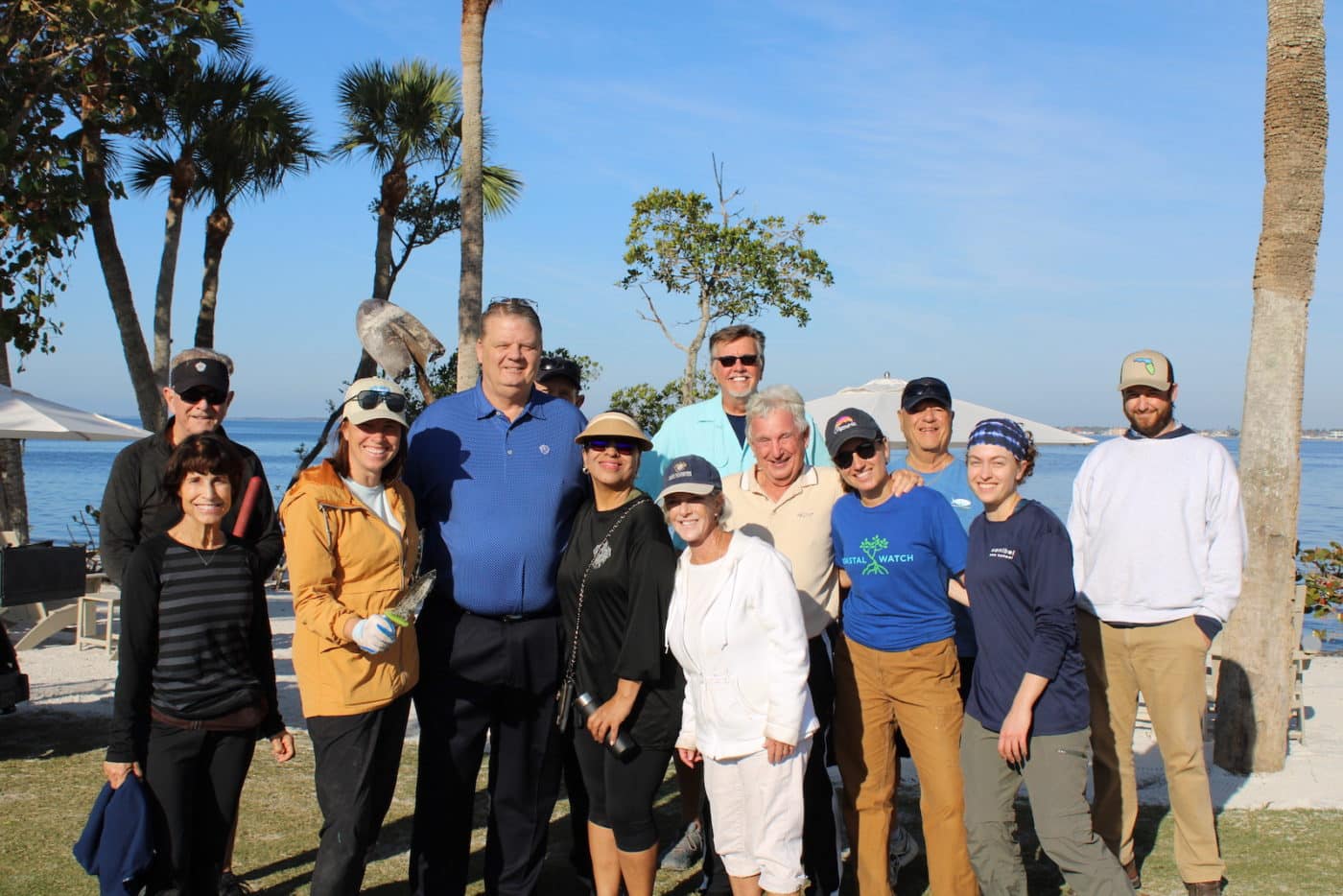 Group smiling with ocean in the background