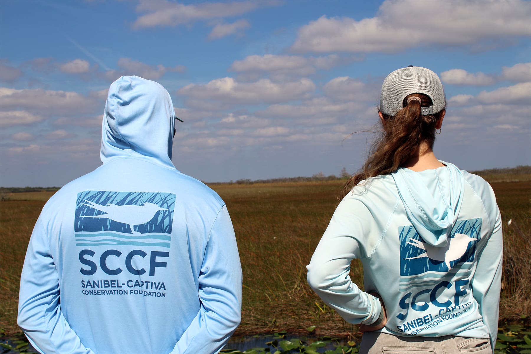 Two people with SCCF shirts looking out into the Everglades