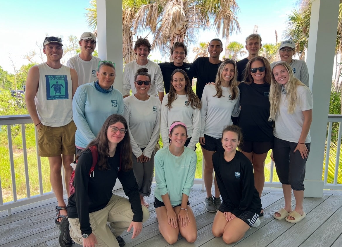 a group of sccf employees smiling outdoors on sanibel