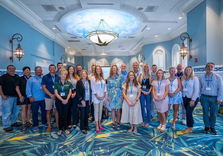 group of 2025 preserving paradise participants stand for indoor photo