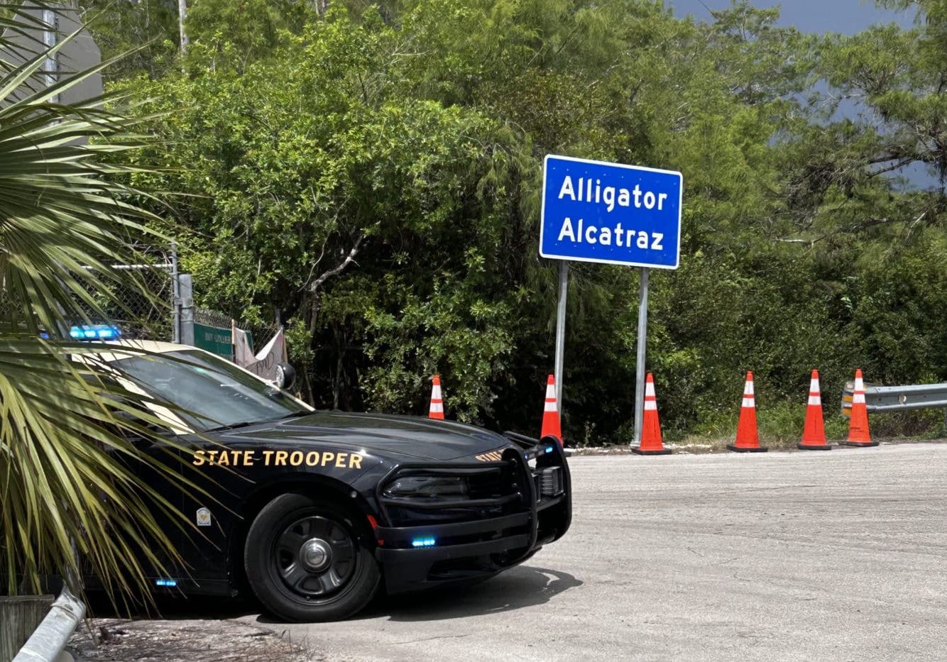 Alligator Alcatraz Sign And Trooper Car