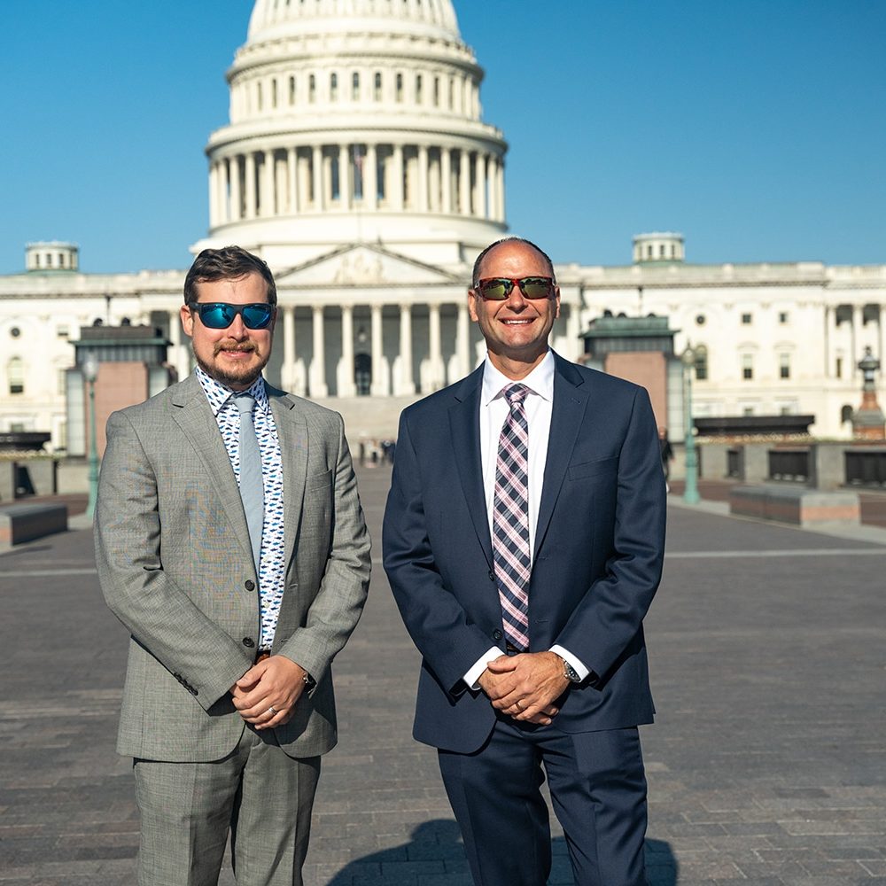 image of two men in front of capitol hill