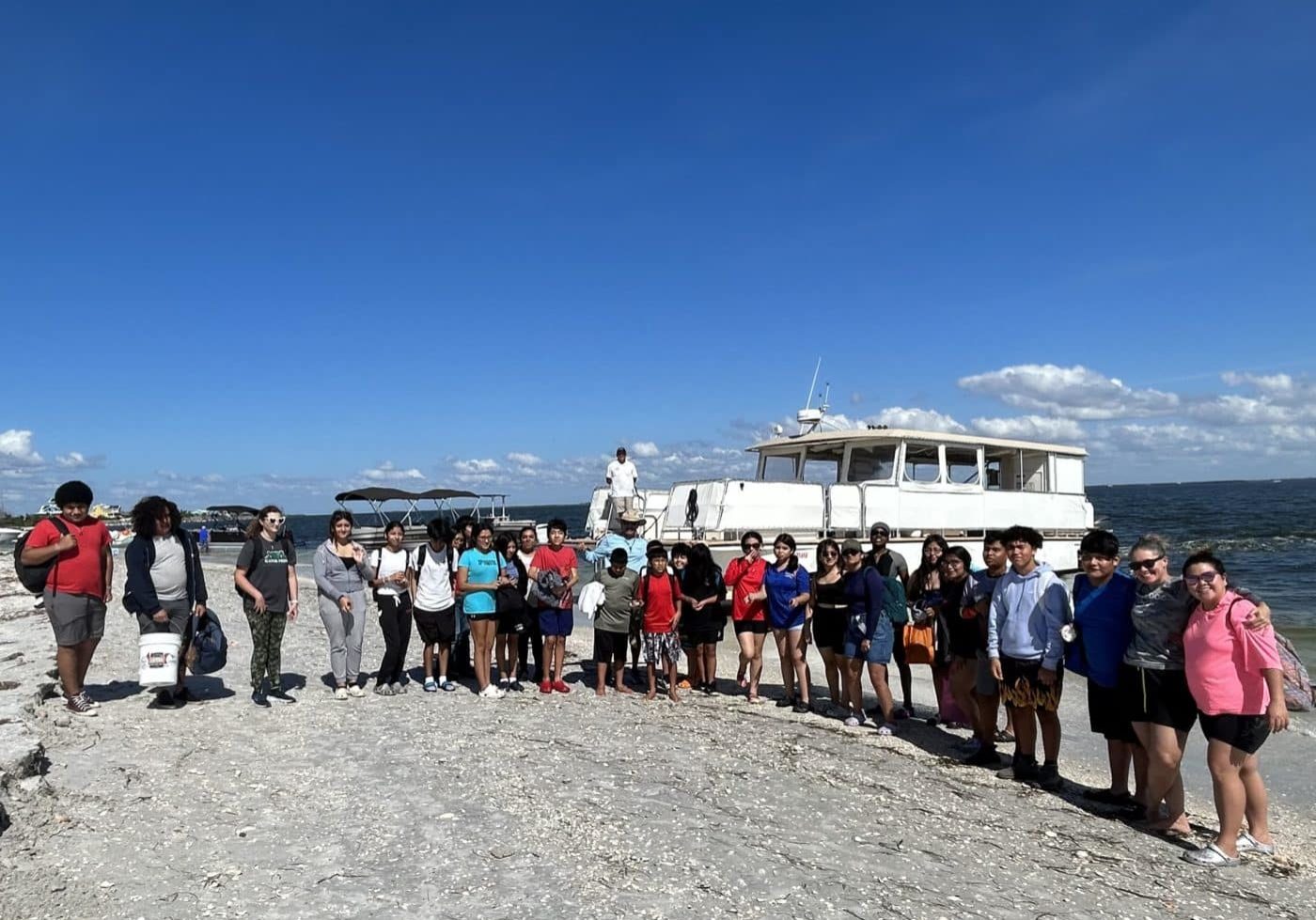 group of students on beach for no child left on shore field trip