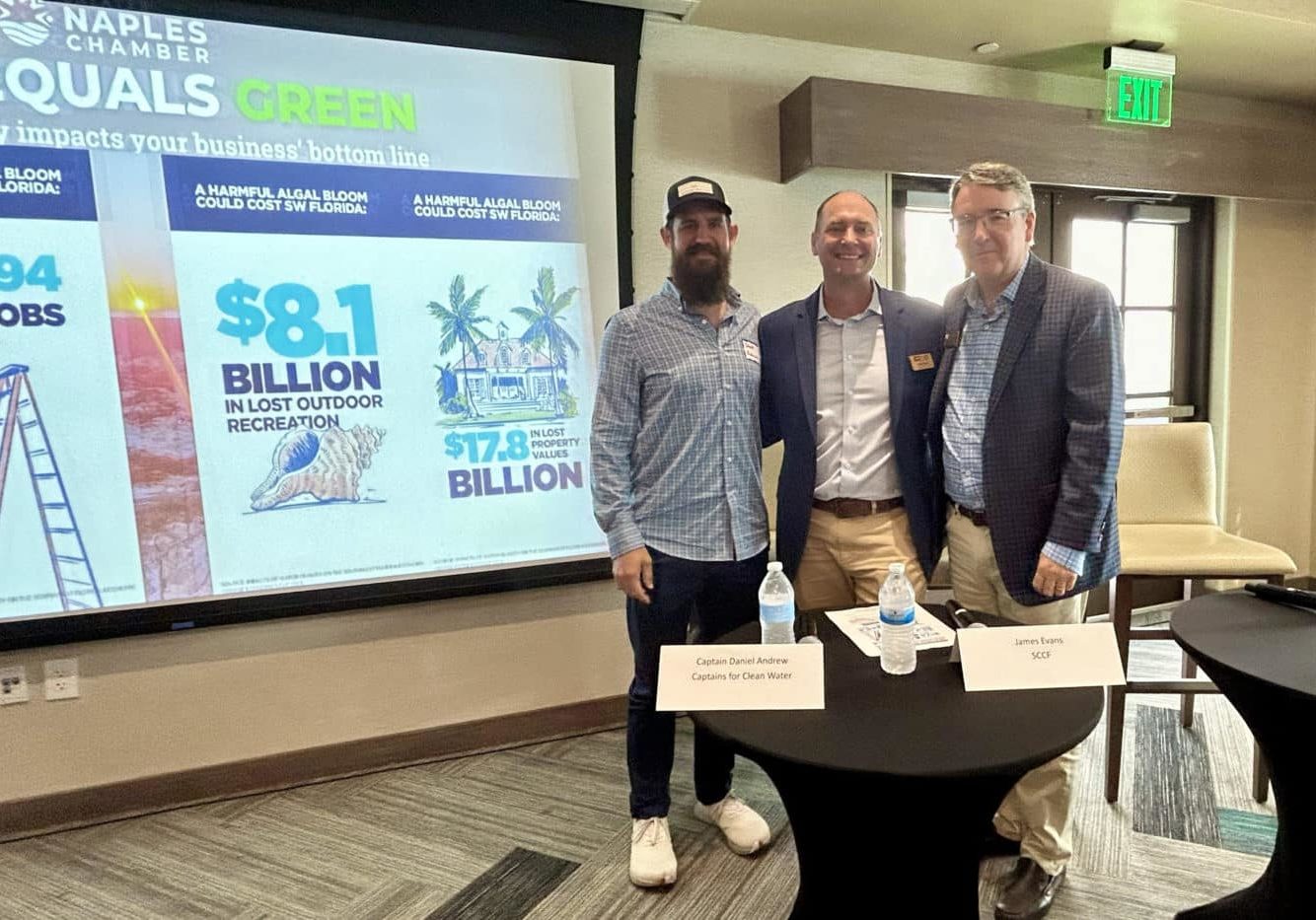 image of three people standing in front of screen